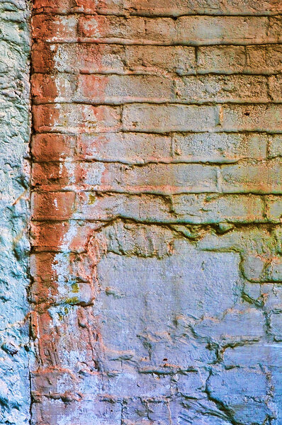An old worn down colorful brick wall texture surface.