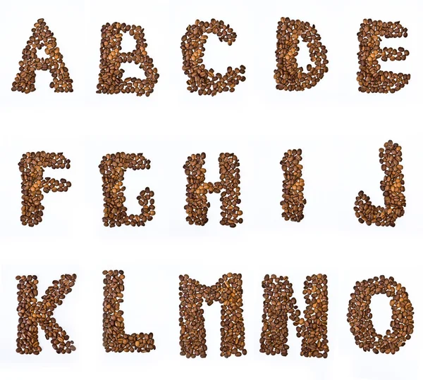 Buchstaben des Alphabets mit dem Kaffee in Korn lizenzfreie Stockbilder