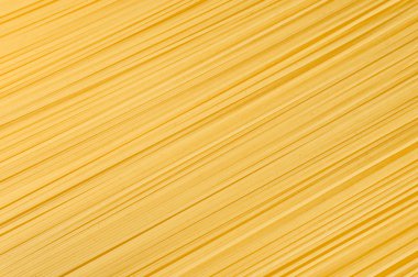 Uncooked spaghetti close-up as a decorative background clipart