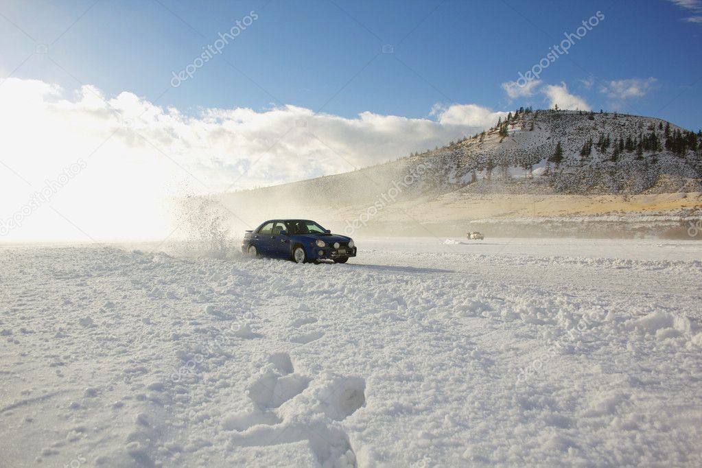 Car racing on a frozen lake with blue sky and dramatic lighting