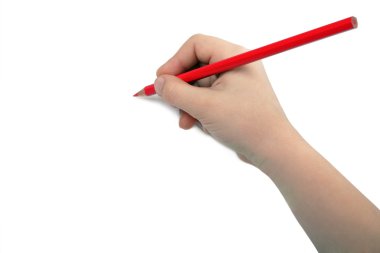 Child hand draws a red pencil. Isolated on white background. Blank sheet. Above view.