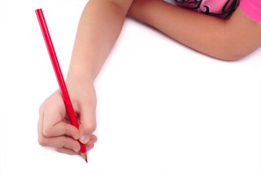 Clipping path included. Child hand draws a red pencil. Isolated on white background. Blank sheet. Above view. clipart