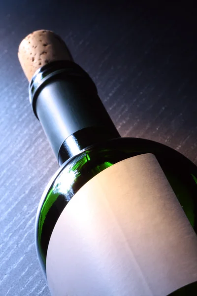 stock image Bottle of wine on a wooden table.