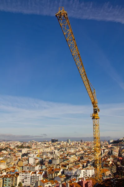 Construction Crane over ancient city Lisbon — Stock Photo, Image