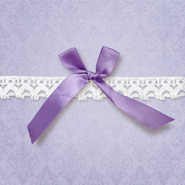 Violet background with bow and lace — Stock Photo, Image
