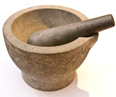 Heavy stone pestle and mortar over a white background clipart