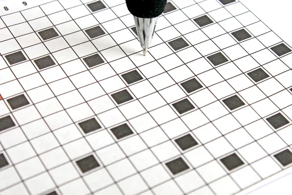 Stock image Closeup of blank crossword with focus on the ballpen