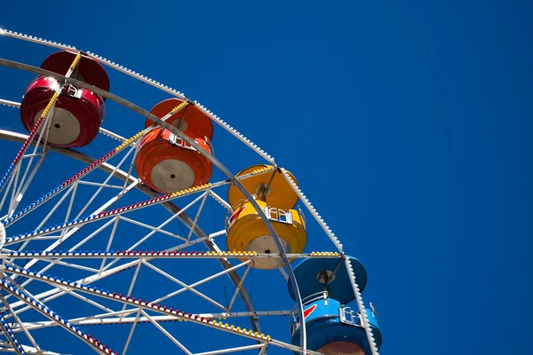 stock image Multi-colored ferris wheel against a blue sky