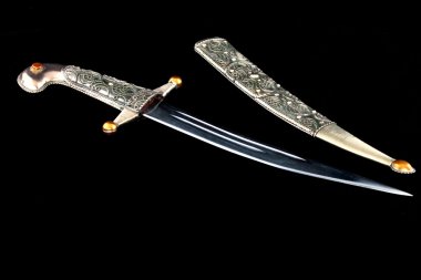 East of ordinary steel dagger with a scabbard and handle, decorated with openwork patterns clipart