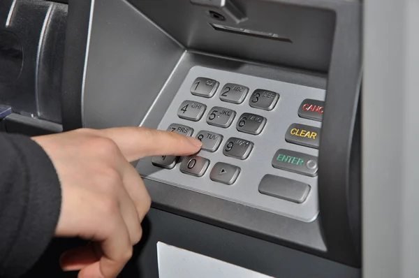 Женщина нажимает кнопку номер на банкомате — стоковое фото