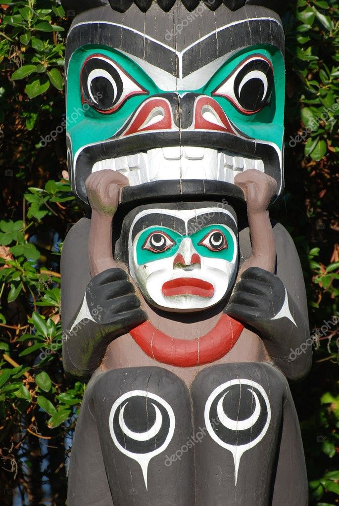 Indian painted totem poles in Canada — Stock Photo © payphoto #5354104