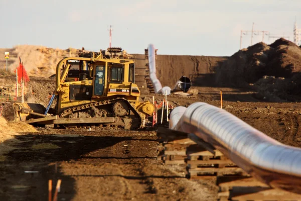 Machinery and pipes laid out for Natural Gas Pipeline Stockafbeelding
