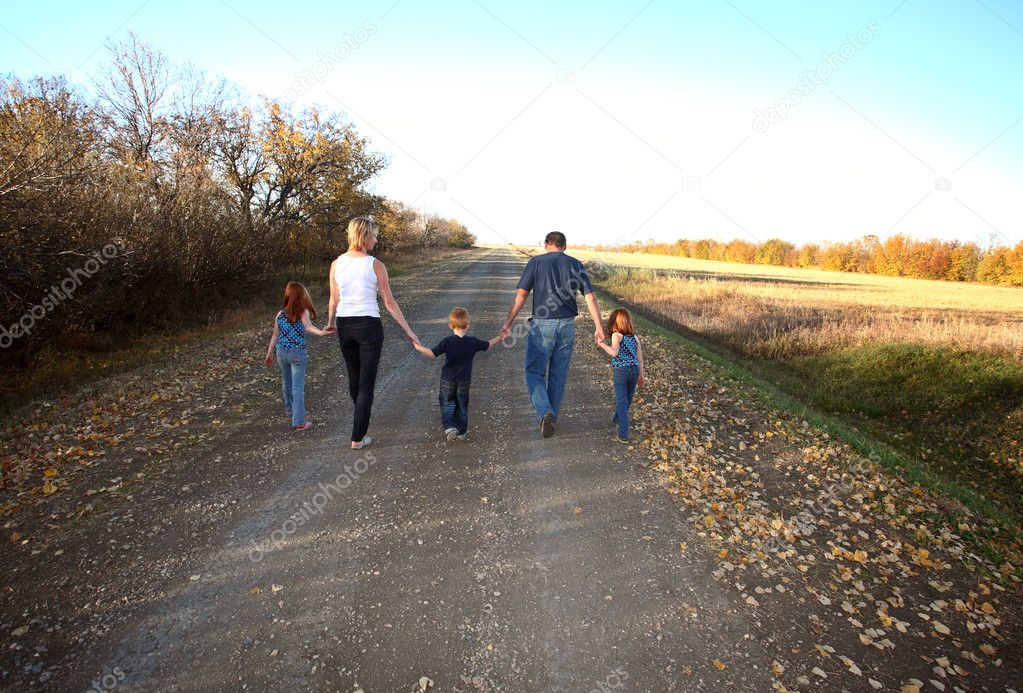 Family walking down Saskatchewan country road