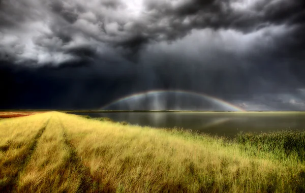 Storm clouds and rainbow over Chaplin Lake Marshes — Stock Photo, Image