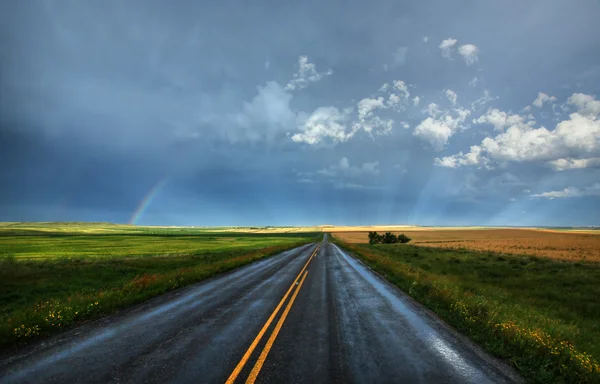 stock image Rainbow and wet country highway in Saskatchewan
