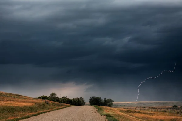 Storm clouds and lightning along a Saskatchewan country road