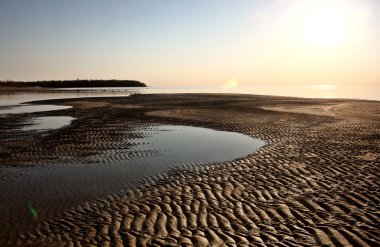 Sand flats along shore of Lake Winnipeg clipart