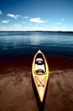 Kayak at waters edge on Lake Winnipeg clipart