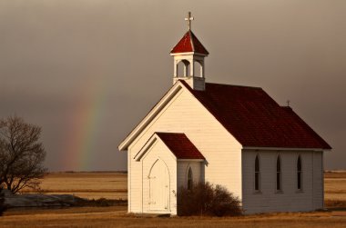 Rainbow behind Saint Columba church clipart