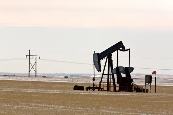 Oil pump jack in winter — Stock Photo, Image