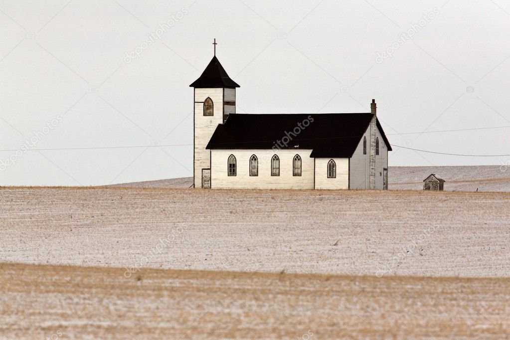 Lone country church on snow covered Prairies