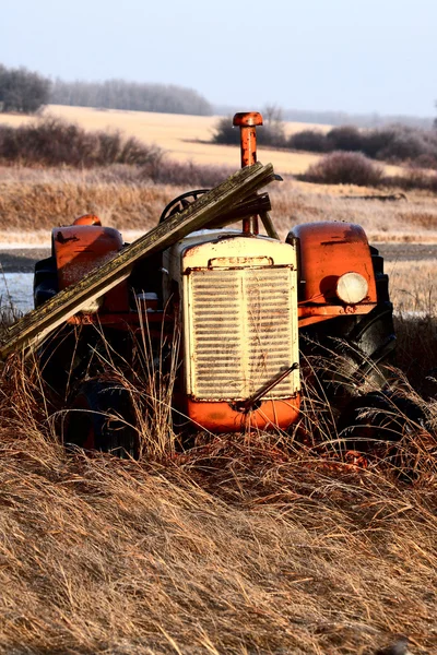 Старий покинутий трактор у високій рослинності — стокове фото