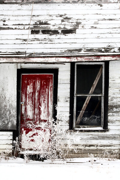 Dilapidated old farm house in winter