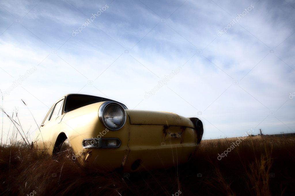 Abandoned yellow foreign car in Saskatchewab lot