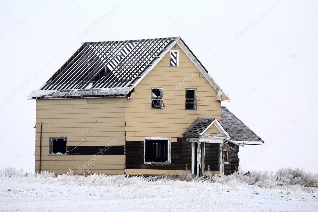 Abandoned roofless farm house in winter