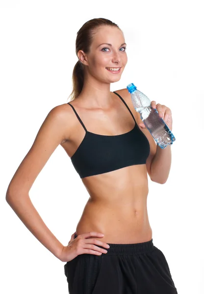 Donna in posa fitness in possesso di bottiglia d'acqua — Foto Stock