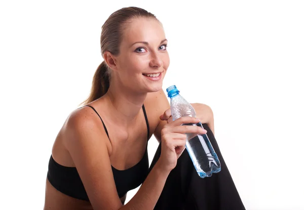 Woman in fitness pose holding water bottle — Stock Photo, Image