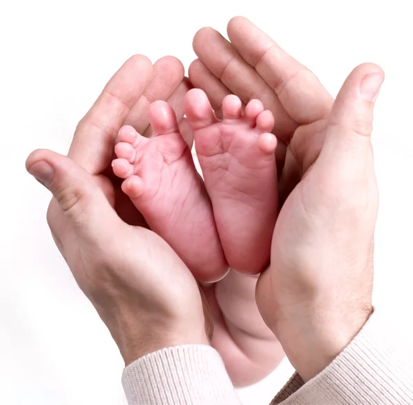 stock image Small baby feets lying on a father hands