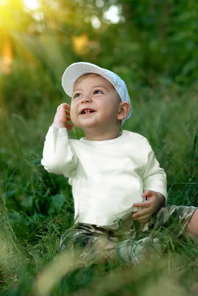 Smiling Boy Sits Grass Sun Beams — Stock Photo, Image