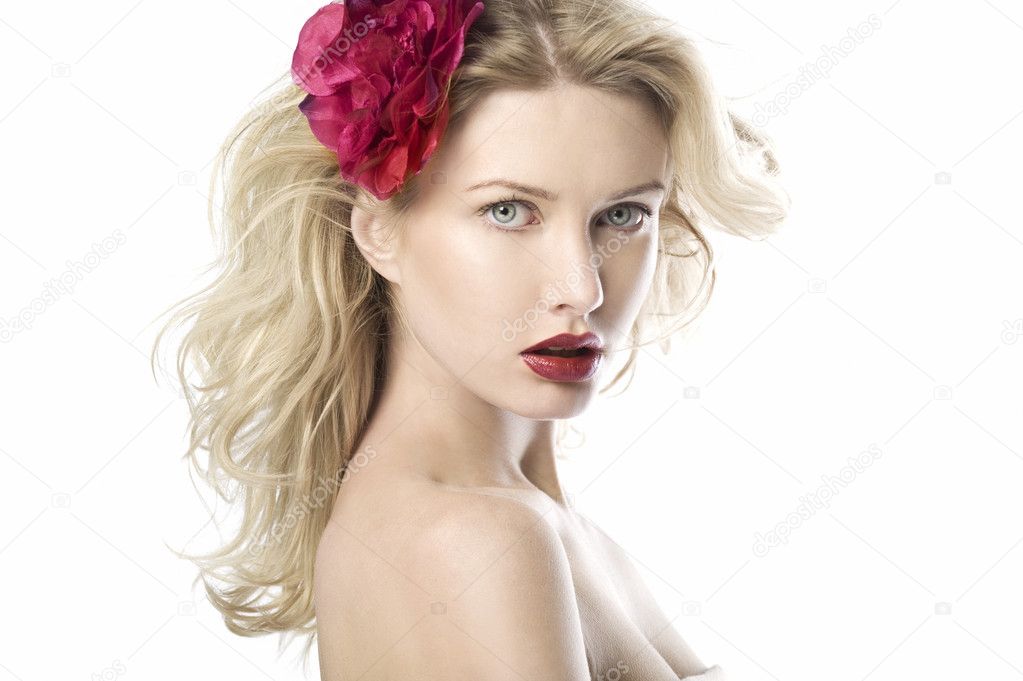 Natural beauty blond women in white background wih red lips and red flower is looking to the camera