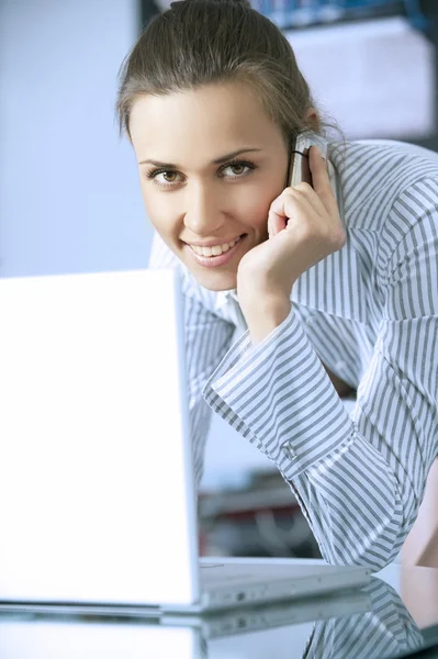 stock image Young women is in a modern office with the laptop with mobile phone