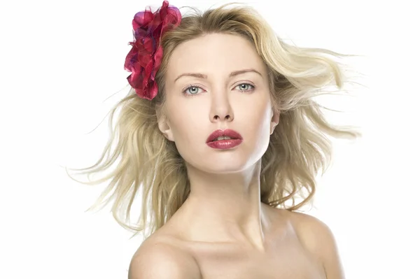 stock image Natural beauty blond women in white background wih red lips and red flower is looking to the camera