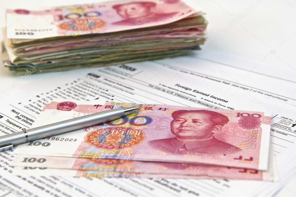 Chinese currency, tax form, silver pen shot under soft lights