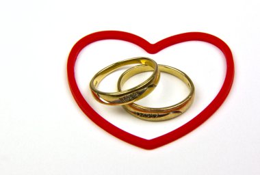 Gold rings in red heart shape clipart