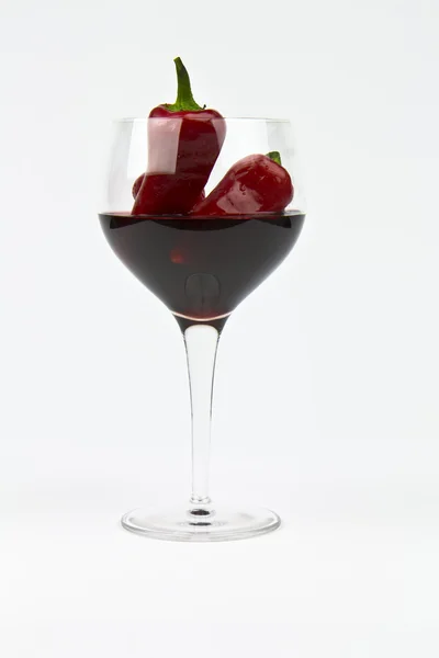 Red wine, glass and hot peppers — Stock Photo, Image