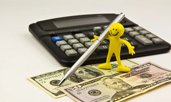 Papper pengar, penna, kalkylator och action figur — Stockfoto