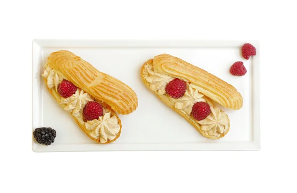 Eclairs with raspberries from above — Stock Photo, Image