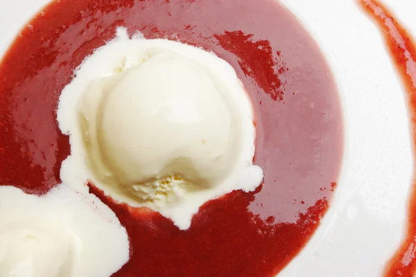 Melting icecream in strawberry syrup — Stock Photo, Image