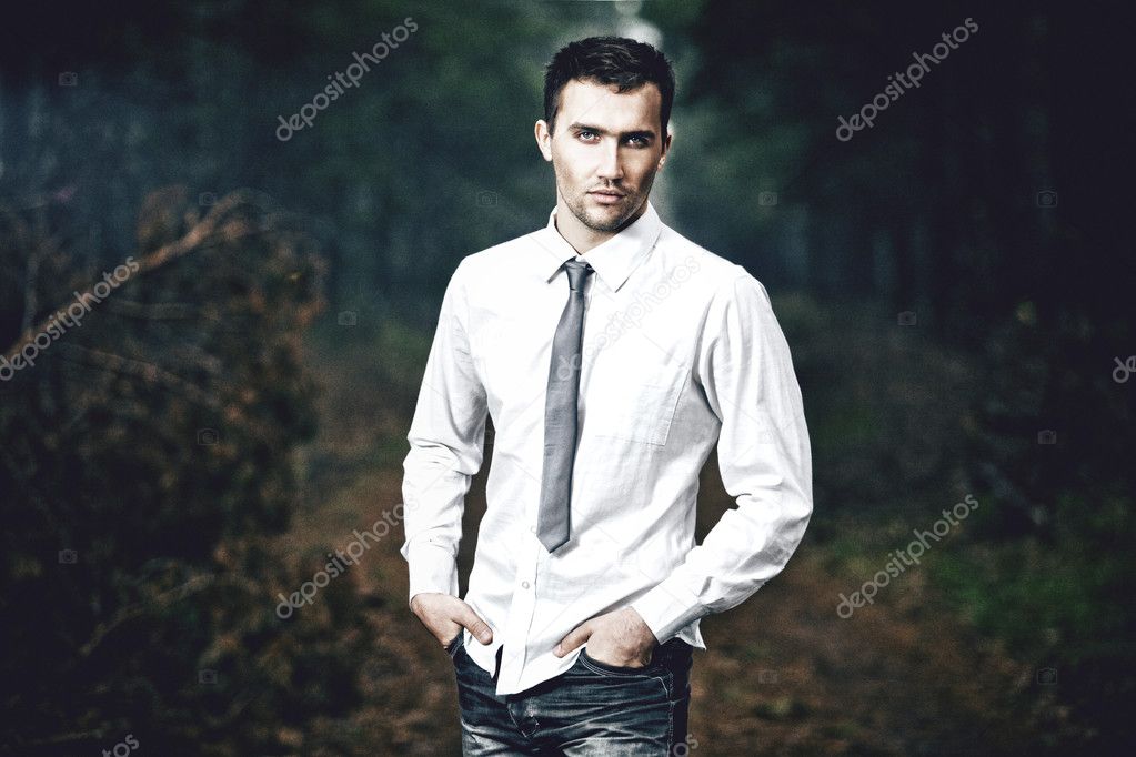 Stylized fashion portrait of young attractive man, outdoors