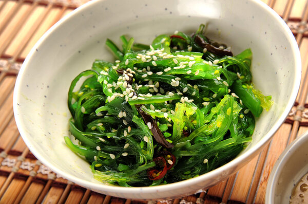 Salad with seaweed with sauce and sesame seeds