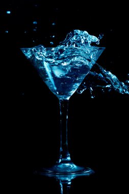 Martini splash on black background close up clipart