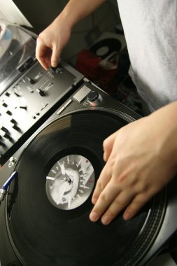 Scratch battle of dj playing on his vinyls hand on clipart