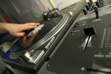 Scratch battle of dj playing on his vinyls hand on clipart