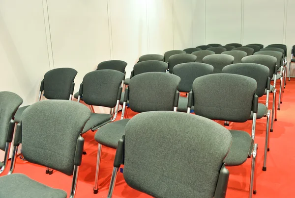 Серые стулья красный пол в комнате для презентаций — стоковое фото