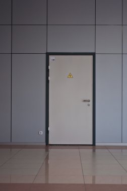 Door to utility room in a modern office building clipart