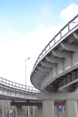 Automobile overpass on background of blue sky with clouds. botto clipart